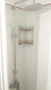 a shower with a shower head in a bathroom at Modern apartment in Torrevieja with terrace – 58 m² in Torrevieja