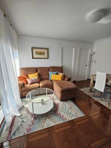 a living room with a couch and a coffee table at La Casuca De Mabel in Revilla de Camargo