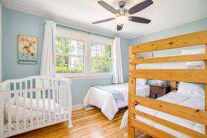 a bedroom with two bunk beds and a ceiling fan at Surf's Up in New Buffalo