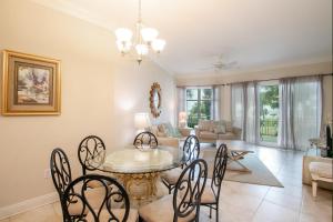 a dining room and living room with a table and chairs at Legacy I 102 in Gulfport