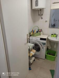 a laundry room with a washing machine and a sink at Apartment Devivi Adris in Split