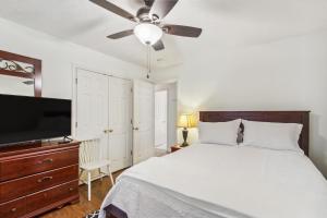 a bedroom with a bed and a ceiling fan at Chatham Getaway with Fireplace, Deck and Gas Grill! in Chatham