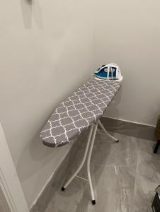 a bench with a hat sitting on top of it at Family Furnished Apartment in Khobar in Al Khobar