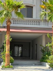 a palm tree in front of a building at Family Furnished Apartment in Khobar in Al Khobar