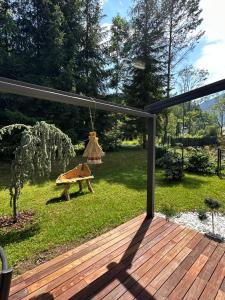 a deck with a view of a yard at Bor in Bor Luxury Apartment with sauna & garden - Kranjska Gora in Kranjska Gora