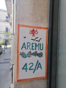 a sign on the side of a building at AREMU in Lecce