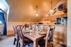 a dining room with a wooden table and chairs at True Downtown Location on Main St - 150 Steps to Gondola, Private Hot Tub, DOG FRIENDLY! SCC3 in Breckenridge