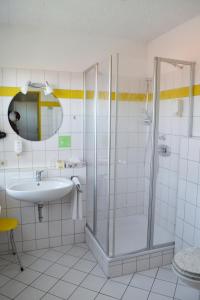 a bathroom with a shower and a sink at Hotel Relax in Singen