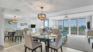 a dining room and living room with a table and chairs at 6415 Midnight Pass #606 in Siesta Key