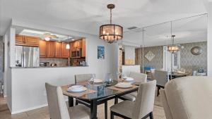 a dining room and kitchen with a table and chairs at 6415 Midnight Pass #606 in Siesta Key