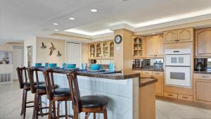 a kitchen with a bar with blue bowls on it at 6415 Midnight Pass #611 in Siesta Key