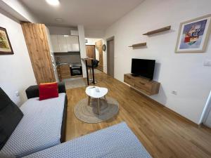 a living room with a couch and a table at Golden Lux Apartments in Skopje