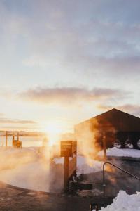 a building with steam coming out of it in the snow at Mysa Nordic Spa & Resort in Saint Peters