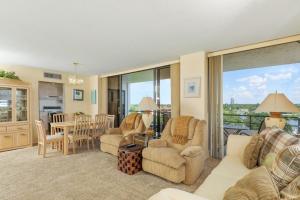 a living room with a couch and chairs and a table at 6415 Midnight Road #709 in Siesta Key