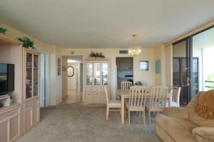 a living room with a couch and a table and chairs at 6415 Midnight Road #709 in Siesta Key