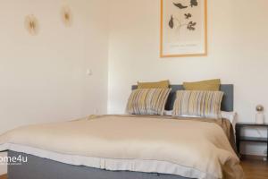a bedroom with a bed with two pillows on it at City-Apartment Straubing in Straubing