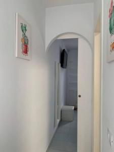 a hallway with a bathroom with a toilet and a television at Bungalow Maspalomas in Maspalomas