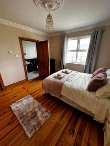 a bedroom with a bed and a large window at Slieve Gullion Valley View in Camlough