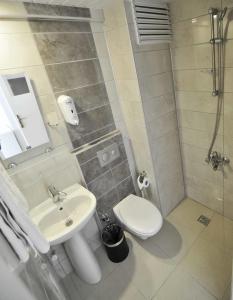 a bathroom with a toilet and a sink at Sun Kiss Hotel in Side