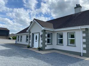 a white house with a garage at Slieve Gullion Valley View in Camlough