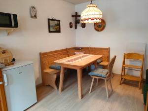 a kitchen with a wooden table and two chairs at Schmidtler`s Nest in Warngau