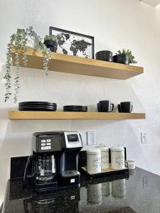 a kitchen with a coffee maker on a counter with cups at Luxurious Condo Walking Distance to San Diego Bay! in San Diego