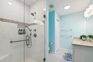 a bathroom with a shower with a glass door at Charming Villages Home with Lanai and Golf Cart! in The Villages +19 photos