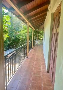 porche de una casa con balcón en Ideal Cottage Holidays-Ιδανικές Εξοχικές Διακοπές en Áyioi Apóstoloi