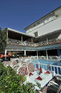 a group of tables and chairs in front of a building at Sun Kiss Hotel in Side
