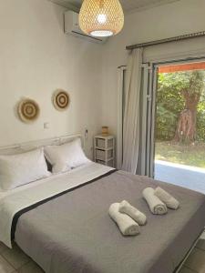 a bedroom with a large bed with towels on it at Villa Penelope in Corfu Town