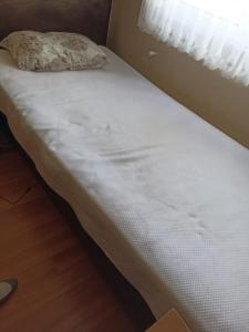a white bed with a pillow on top of it at Deniz ve Doğa Manzaralı in Fındıklı