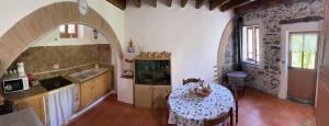 a kitchen with a table with a table cloth on it at A Ca’ da Zia in Corte