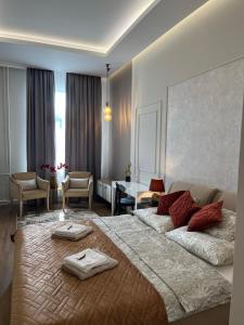 a bedroom with a large bed with two towels on it at Visit Debrecen 3 Apartman in Debrecen