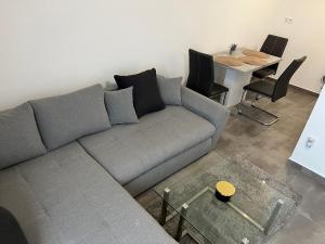 a living room with a couch and a table at Furó-Lak Lake View in Hajdúszoboszló