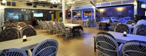 a dining room with white tables and chairs at Sun Kiss Hotel in Side