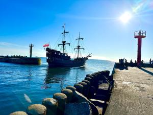 ダルウフコにあるSunset Apartments Kropla Baltykuの海賊船が桟橋に停泊