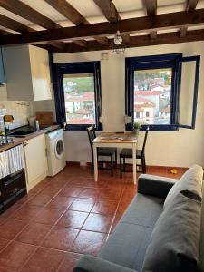 a living room with a couch and a table at Casa de pescadores con vistas al mar in Cudillero +10 photos