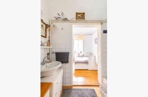 a white bathroom with a sink and a mirror at MARONA - Home Studio - where Music and Art meet Business in Perchtoldsdorf