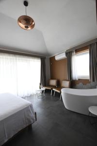 a hotel room with a bath tub and a couch at The APARTMENT in Tivoli