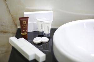 a bathroom with a toilet and some products on a table at Seaside Apartments in Vlorë +53 photos