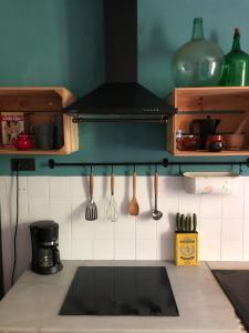 a kitchen with a sink and utensils on the wall at CASA LA BIERA in La Velilla