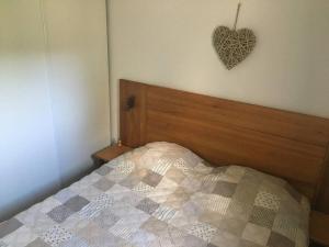 a bedroom with a bed with a heart on the wall at Logement au pied des pistes Superdevoluy in Le Dévoluy