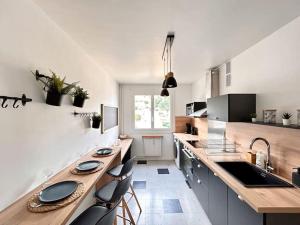 a kitchen with a wooden counter top and a sink at Le Bobohème - Wifi - Parking in Royat