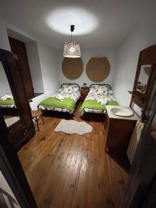 a small room with two beds and a mirror at CASA LA BIERA in La Velilla