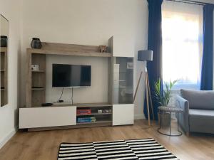 a living room with a flat screen tv on a wall at Błękitne Studio in Żywiec