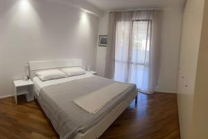 a bedroom with a large bed and a window at Magici momenti-Bordighera in Bordighera