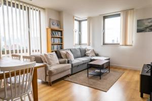 a living room with a couch and a table at City Air Apartments - SHADWELL - GREAT TRANSPORT LINKS in London