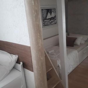 a small room with a bunk bed and a ladder at Apartmani Nis in Niš