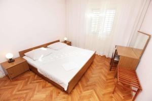 Postel nebo postele na pokoji v ubytování Apartments Dubravka
