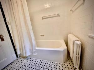 a white bath tub in a bathroom with a shower at Beacon Hermitage in Beacon